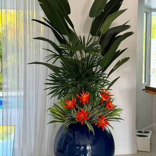 Mélange de plantes tropicales dans pot globe bleu cobalt