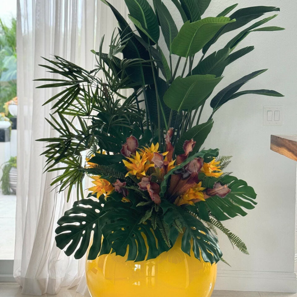 Mélange de plantes tropicales dans pot globe jaune